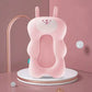 Coussin de bain en forme de lapin rose.