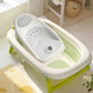 Transat-baignoire pour bébé de couleur gris dans une baignoire pliable.